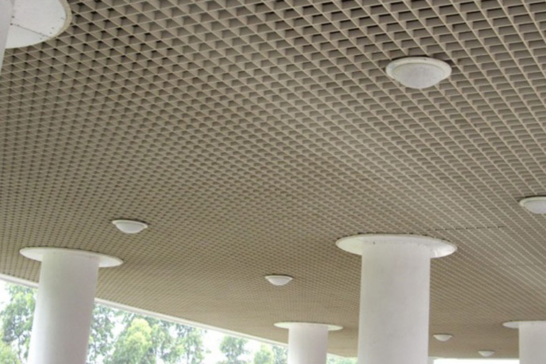 Aluminum ceilings are an excellent choice for a modern house. They are fashionable in addition to being simple to install and simple to keep up. They are also long-lasting and can survive for several years. Aluminum ceilings are an excellent method to increase the value of your home and make it more pleasant to live in for you and your family. Let's get acquainted with what aluminum-suspended ceilings are there as well as their definitions. What is suspended ceiling?  A suspended ceiling system is a false ceiling that is constructed as part of the construction process below the primary foundation. Its purpose is to reduce the overall ceiling height while also concealing the plumbing, electrical, and insulation services. When developing or updating the facilities for a large room, suspended ceilings are a fantastic alternative to consider. The lighting, air ventilation, sound quality, and insulation in open-plan areas may all be better controlled with the help of this ceiling system.  In commercial structures, suspended ceilings are quite common because they offer an advantageous space for concealing unsightly wiring and installations that, if left exposed, might adversely alter the interior design of the building. They refer to a style of finishing in which the ceiling of the room is suspended from the framework of the ceiling above it in the room. It is possible to suspend it from either the roof itself or from a ceiling deck that is composed of structural framing joints. Benefits of the suspended ceiling:  Following are a few benefits of a suspended ceiling.  1.Soundproofing:  One of the most compelling arguments in favor of installing a suspended ceiling is the soundproofing properties it possesses. Acoustic tiles are constructed in such a way as to absorb the sound that is produced within a space, and the gap that exists between the tiles and the ceiling deck also contributes to noise reduction. The ceiling of a room can serve two purposes: it can be an effective sound barrier between floors, or it can work very successfully to improve the overall acoustics of the room when sound-absorbing tiles are used. 2.Aesthetically pleasing:  The fact that suspended ceilings can have tiles that are customized to fit their needs also looks wonderful. They give a pleasing aesthetic look. You have a broad variety of color options to select from, which will allow you to give your room or office the stylish new look that it so richly deserves. In addition to that, there is a huge variety of both designs and styles from which to select. Customers can select from a large number of different finishes because of a suspended ceiling's adaptability in terms of styles and designs. 3.Energy efficiency:  Not only are suspended ceilings fantastic for reducing noise, but they also look great. They are also wonderful at maintaining the temperature in your space at a constant level. They narrow the area between the floor and ceiling deck, so lowering the volume of available space through which air can move. As a result, your temperature regulation system does not have to work itself to the same degree. 4.Safety: In certain circumstances, such as passageways that serve as exits in the event of a fire, a fire-rated ceiling will be obligatory. A fire-rated ceiling has been evaluated by the manufacturer to ensure that it will maintain its structural integrity for a certain amount of time. This test also determines how well the ceiling can contain a fire and stop it from spreading from one room to another. What is aluminum suspended ceilings?  Aluminum Suspended Ceilings are sometimes referred to as drop ceilings. It is a form of finish that is hung in a room just beneath the primary aluminum ceiling framework. This indicates that an aluminum-suspended ceiling does not provide a permanent structural foundation but rather functions as a covering for the more substantial framework that is located above it. If you want to hide the ducting and pipes in your ceiling, lower your ceiling, or save money on your utility costs, one type of aluminum ceiling is an excellent option to consider. Aluminum Suspended ceilings and metal ceiling tiles are developed and built to the highest standards, and they offer a highly effective solution for a variety of applications. Aluminum Suspended ceilings and metal ceiling tiles are available in a variety of colors and styles. Applications of aluminum suspended ceiling: Aluminum suspended ceilings are structural elements that are frequently used in buildings that are designed for industrial purposes. They contribute to the comfort of the space by playing a role in providing various requirements, such as heat insulation, sound insulation, lighting, and ventilation of the area. In addition, suspended ceilings are favored because they raise the aesthetic value of the area, conceal the installations, and produce the appearance of a flat ceiling. What aluminum-suspended ceilings are there?  Let’s know ‘’what aluminum suspended ceilings are there?’’  The lay-in type of metal ceiling, the clip-in type of metal ceiling, the plank type of metal ceiling, and the open-cell type of metal ceiling are some of the most important variations of Aluminum Suspended Ceiling. There is a wide variety of options available for these ceilings, including thicknesses, quality levels, coatings, and colors. These ceiling systems made of aluminum are extremely long-lasting and sturdy. When compared to any other ceiling, this one is significantly simpler to clean and install, and you have the option of using it for either home or commercial/industrial purposes, depending on your specific requirements. Pipes, ducts, and cables are relatively easy to conceal behind these ceilings thanks to their design.   Advantages of aluminum suspended ceilings: 1.Easy installation:  Due to the ease and speed with which they may be installed, aluminum suspended ceilings are frequently utilized in areas with expansive floor plans. The fast tensile spring attachment is employed across typical ceiling grid systems to provide a level of simplicity that is unmatched by any other option. This indicates that you will be able to finish new construction or renovations more quickly as you won't have to wait for a standard drywall ceiling to be finished before you can move on to the next step. 2.Easy to repair:  If there is a water leak or some other damage to the aluminum suspended ceiling system or the building elements that are housed above it, repairs and replacements are simple and may be done in a short amount of time. It is possible to replace a broken panel with a brand-new one at any time without affecting the functionality of the system as a whole. If all that needs to be done to fix the problem is to clean up the mess left by a water leak, the aluminum ceiling panels can be removed, cleaned, and then put back in place. 3.Acoustics: Aluminum suspended ceilings that have been equipped with acoustics are capable of blocking all of the sounds that come from the outside. This is an excellent component to install in workplaces or leisure rooms to make those areas significantly cozier and quieter. A diverse offering of colors and kinds of material to pick from. In addition, there are some panels available for aluminum suspended ceilings that offer an increased level of fire safety, making this material another option that is risk-free to use. 4.Light Reflectance:  The selection of an aluminum-suspended ceiling provides the space with illumination at the appropriate level while simultaneously lowering the amount of electrical energy that is necessary to illuminate the area. This is especially important in areas where powerful lighting is required. 5.Customization: Your preferences can be taken into consideration while designing the ceiling made of aluminum suspended metal. This involves providing a wide variety of color options and surface finishes, as well as working with any distinctive aspects of your office or commercial building to ensure that the ceiling complements those aspects in an aesthetically pleasing way.  6.Insulation:  Installing a suspended ceiling, which lowers the overall ceiling height within a space, is an effective way to capture the warmer air that is already present in the room and prevent it from escaping through the top of the ceiling. This can be accomplished by simply installing a suspended ceiling. This not only makes the area more comfortable, but it also reduces the amount of money spent each month on energy costs. Conclusion:  Aluminum-suspended ceilings are utilized in a wide variety of applications. We hope you're clear about what aluminum suspended ceilings are there. ManyBest is dedicated to providing the highest possible level of customer satisfaction by offering knowledgeable and professional services as well as high-quality supplies. We can help you install suspended ceilings quickly and efficiently to ensure that there is the least interruption caused to your project; thus, please get in touch with us as soon as possible to learn more about how we can assist you.